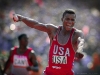 Carl Lewis reacts in joy after seeing a world record time posted on the scoreboard as he crosses the finish line in the men\'s 400 meter relay. Lewis won his 4th gold medal of the games when he anchored the relay team to a 37.83 clocking at the 1984 Olympics in Los Angeles.